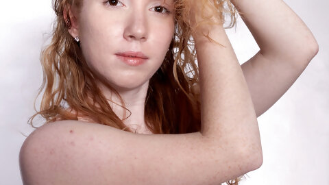 Petite curly haired redhead Nicki Blue flaunts her bush on a fitness ball